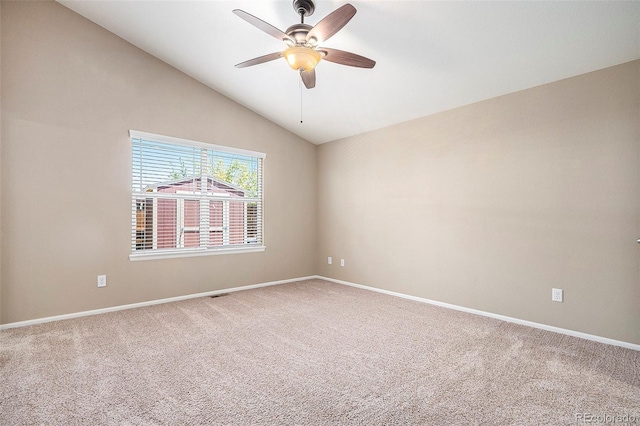 spare room featuring ceiling fan, carpet floors, and vaulted ceiling