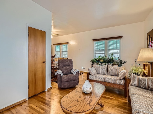 living room with light hardwood / wood-style flooring, a wealth of natural light, and ceiling fan