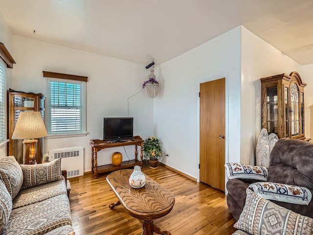 living room featuring hardwood / wood-style flooring and radiator heating unit