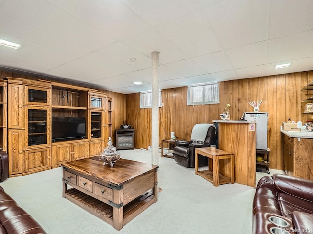 carpeted living room with wooden walls