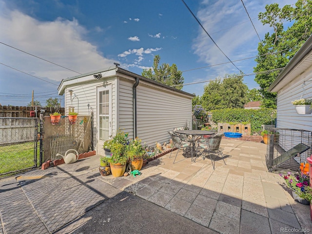 view of patio / terrace with an outbuilding