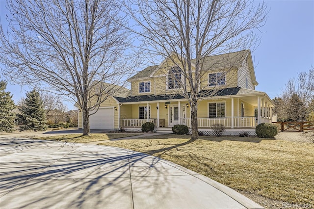 view of front of property featuring fence, a porch, concrete driveway, a front lawn, and a garage