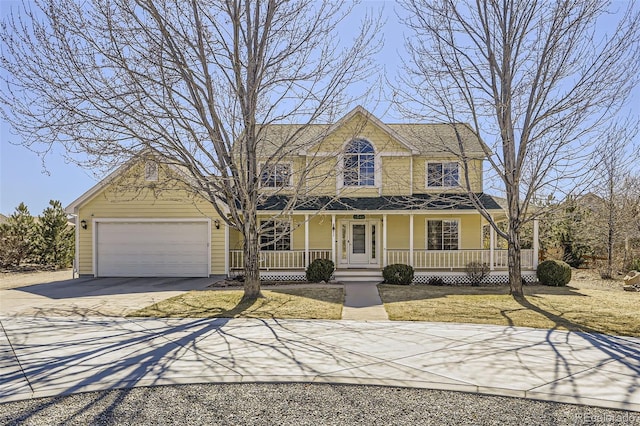 view of front of house featuring a garage, a porch, and driveway