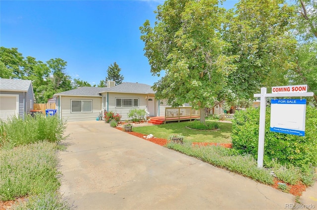 view of front of house featuring a front yard and a deck