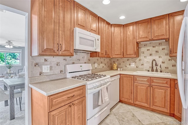 kitchen featuring ceiling fan, sink, white appliances, decorative backsplash, and light tile patterned flooring