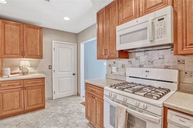 kitchen with decorative backsplash, light tile patterned flooring, and white appliances