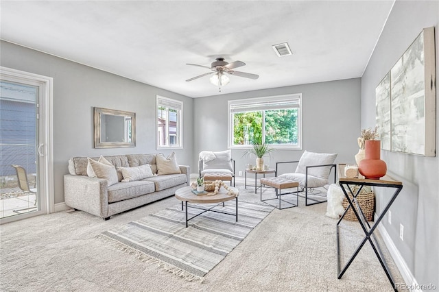 carpeted living room featuring ceiling fan