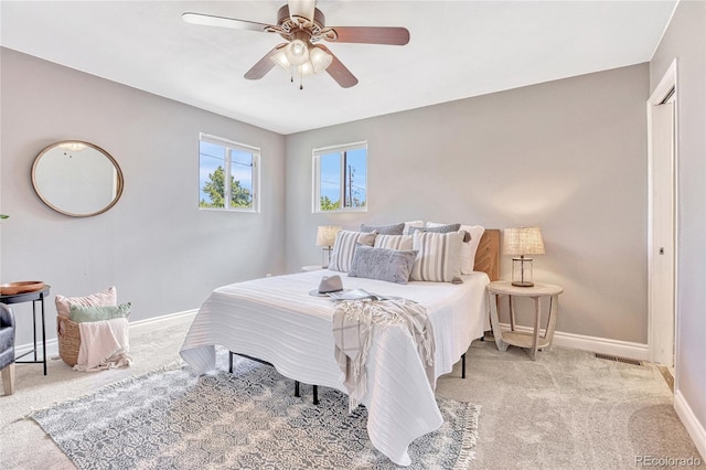 carpeted bedroom with ceiling fan and a closet