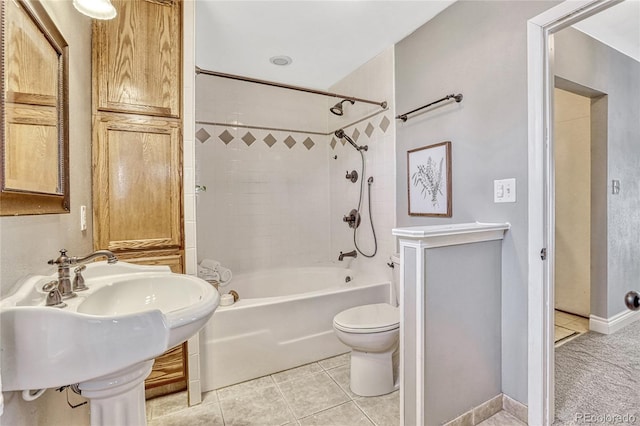 full bathroom featuring tile patterned floors, toilet, sink, and tiled shower / bath