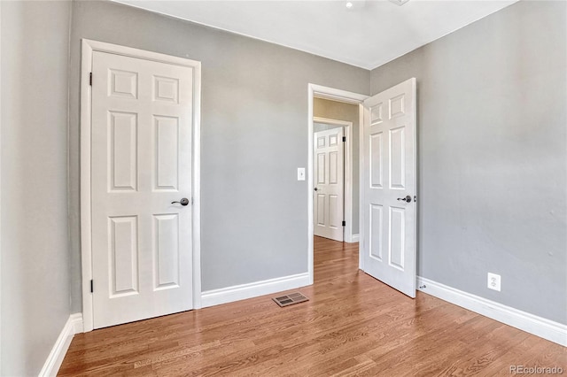 unfurnished bedroom featuring hardwood / wood-style floors