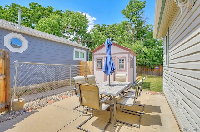 view of patio featuring a shed