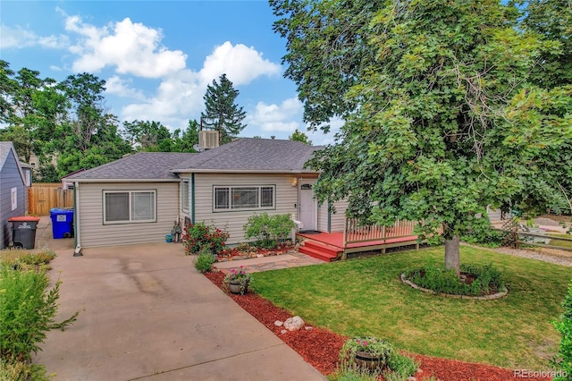 view of front of property with a deck, a front yard, and central air condition unit