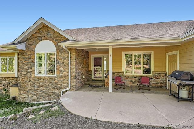 557 Highpoint Cir, Black Hawk, CO 80422 - doorway to property featuring stone siding and a shingled roof