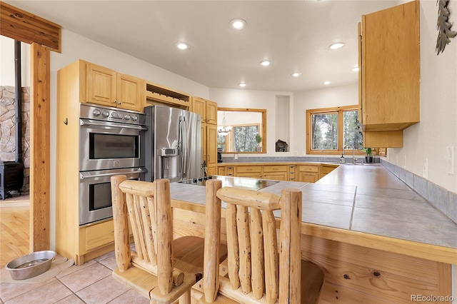29266 S Sunset Trl, Conifer, CO 80433 - kitchen featuring appliances with stainless steel finishes, light brown cabinets, recessed lighting, light tile patterned flooring, and light countertops