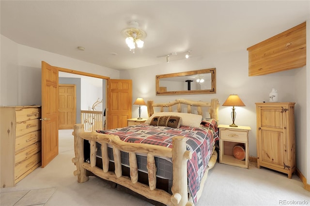 29266 S Sunset Trl, Conifer, CO 80433 - bedroom with light colored carpet and rail lighting