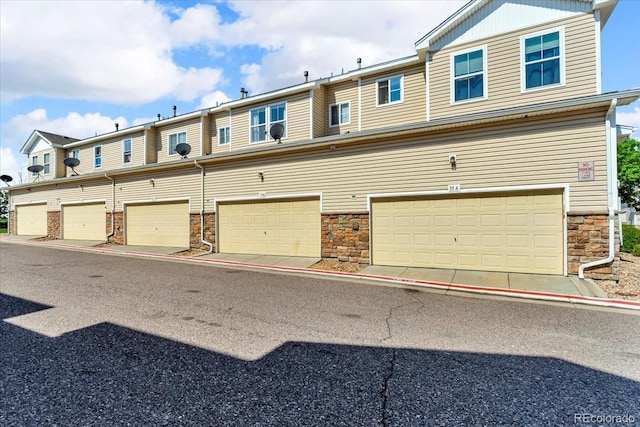 9758 Laredo St Unit 35B, Commerce City, CO 80022 - view of front of home featuring stone siding and an attached garage