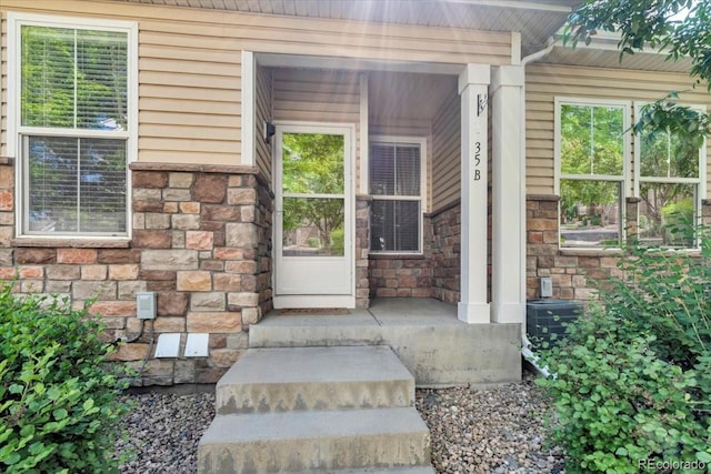 9758 Laredo St Unit 35B, Commerce City, CO 80022 - property entrance featuring stone siding and a porch