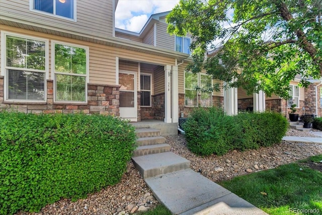 9758 Laredo St Unit 35B, Commerce City, CO 80022 - property entrance with stone siding and covered porch