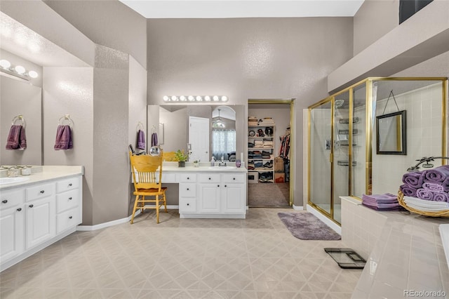 2938 S Zeno Way, Aurora, CO 80013 - full bathroom featuring a stall shower, two vanities, tile patterned floors, and a walk in closet