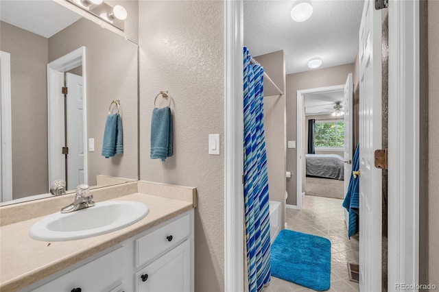 2938 S Zeno Way, Aurora, CO 80013 - bathroom featuring vanity, connected bathroom, curtained shower, tile patterned floors, and a textured ceiling