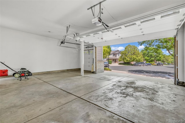 2938 S Zeno Way, Aurora, CO 80013 - garage featuring a garage door opener and baseboards