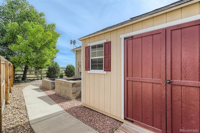 view of shed with fence
