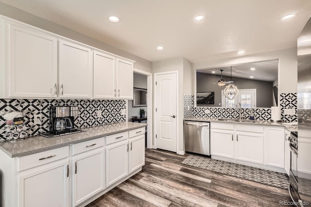 kitchen featuring a sink, white cabinetry, vaulted ceiling, appliances with stainless steel finishes, and dark wood finished floors