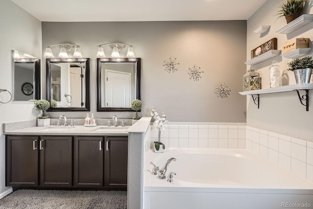 full bathroom featuring double vanity, a sink, and a bath