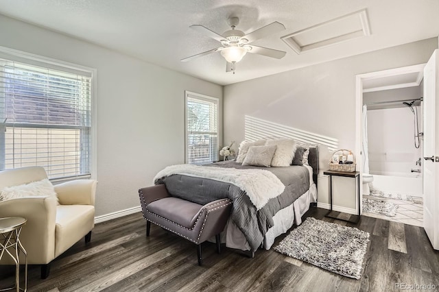 bedroom featuring dark wood-style floors, attic access, baseboards, and ceiling fan