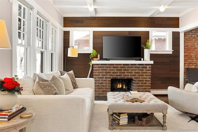 living area with coffered ceiling, wood walls, a fireplace, a baseboard heating unit, and beam ceiling