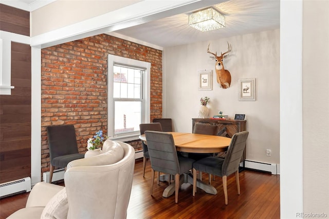 dining room featuring brick wall, a baseboard radiator, baseboard heating, and hardwood / wood-style floors