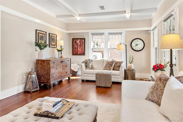 living area featuring baseboards, beam ceiling, visible vents, and wood finished floors