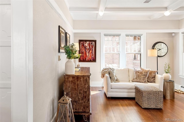 sitting room with hardwood / wood-style floors, beamed ceiling, coffered ceiling, and baseboards