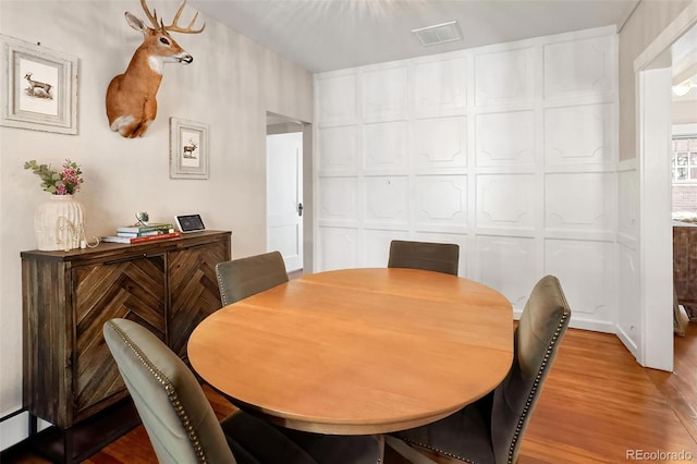 dining space featuring visible vents and light wood finished floors