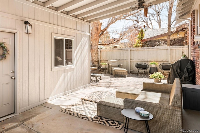 view of patio / terrace featuring a grill and fence