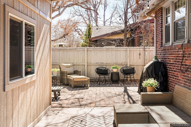 view of patio / terrace featuring a grill and fence