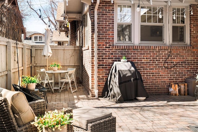 view of patio featuring outdoor dining area and a fenced backyard