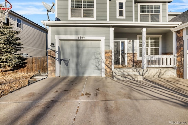 doorway to property with a garage and covered porch