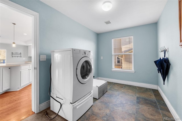 laundry area featuring a healthy amount of sunlight and washer / clothes dryer