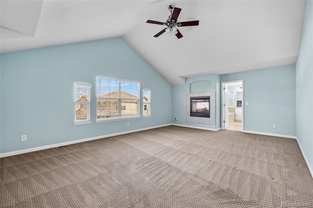 unfurnished living room featuring vaulted ceiling, a multi sided fireplace, carpet, and ceiling fan