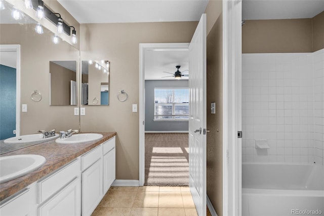 bathroom featuring tile patterned flooring, vanity, tiled shower / bath, and ceiling fan