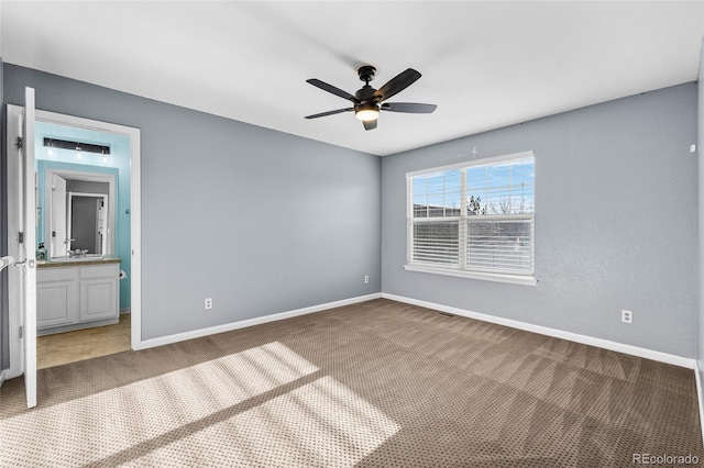 carpeted empty room featuring ceiling fan