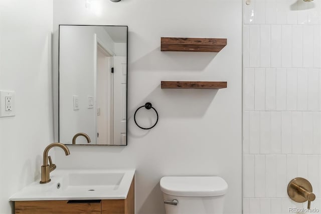 bathroom featuring toilet and vanity