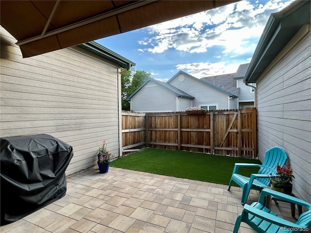 10087 E Hawaii Pl, Aurora, CO 80247 - fenced backyard featuring a patio and grilling area