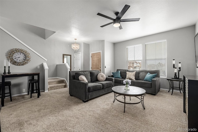 carpeted living room featuring a textured ceiling and ceiling fan