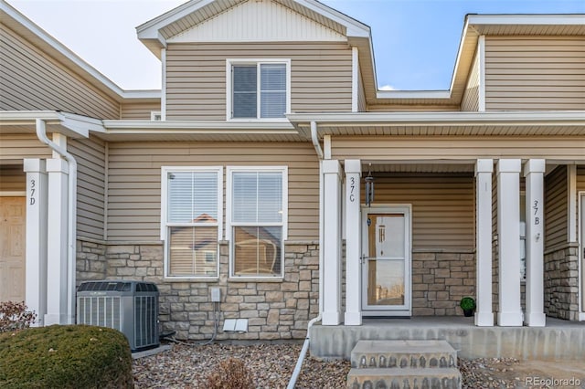 property entrance featuring cooling unit and covered porch