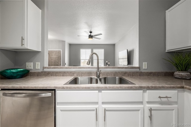 kitchen with sink, dishwasher, ceiling fan, white cabinetry, and a textured ceiling