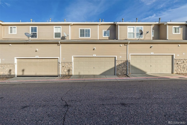 9758 Laredo St Unit 37C, Commerce City, CO 80022 - view of front facade with a garage and stone siding