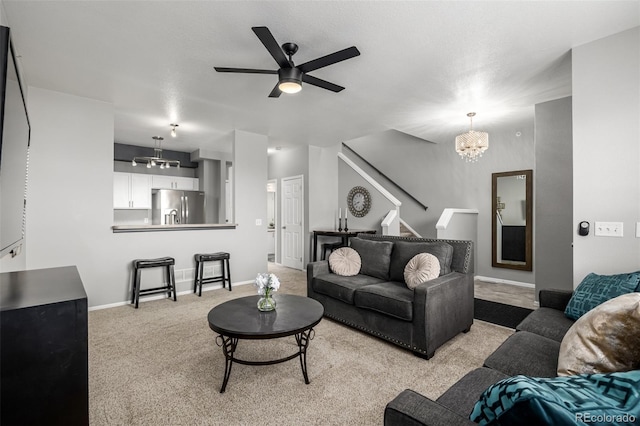 9758 Laredo St Unit 37C, Commerce City, CO 80022 - carpeted living area featuring a chandelier, stairs, ceiling fan, and baseboards