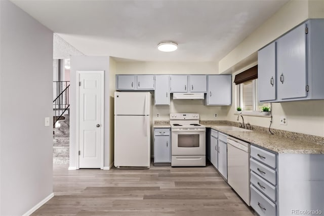 2212 S Naples Way, Aurora, CO 80013 - kitchen with white appliances, under cabinet range hood, light wood-style floors, and light countertops